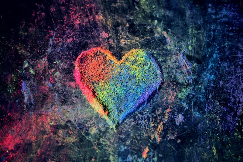 Heart created by chalk dust in rainbow colors